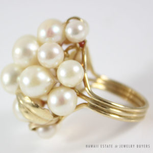 This Ming's Hawaii piece features a beautiful white shining pearls varying in size from approximately 4.8-7MM. There are 14K Yellow Gold swirl accents among the pearl cluster, a beautiful statement piece from Ming's Hawaii. STAMPED: MING'S 14K Size: Falls between 5.75-6 STAMPED: MINGS 14K